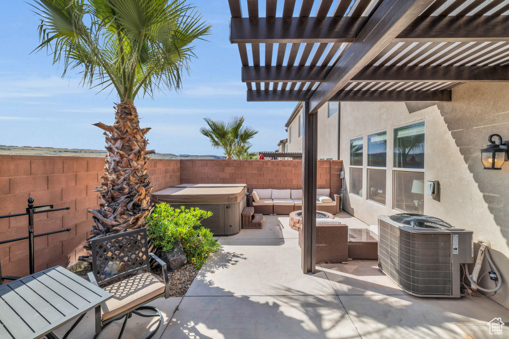 View of patio / terrace featuring central air condition unit, an outdoor hangout area, a pergola, and a hot tub