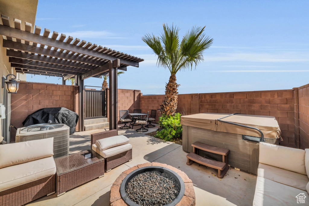 View of terrace with an outdoor living space with a fire pit, a pergola, and a hot tub