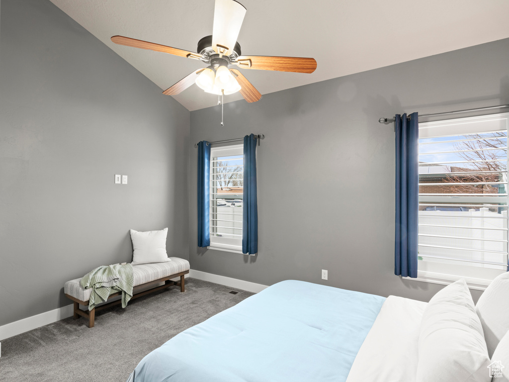 Bedroom featuring light carpet, vaulted ceiling, and ceiling fan