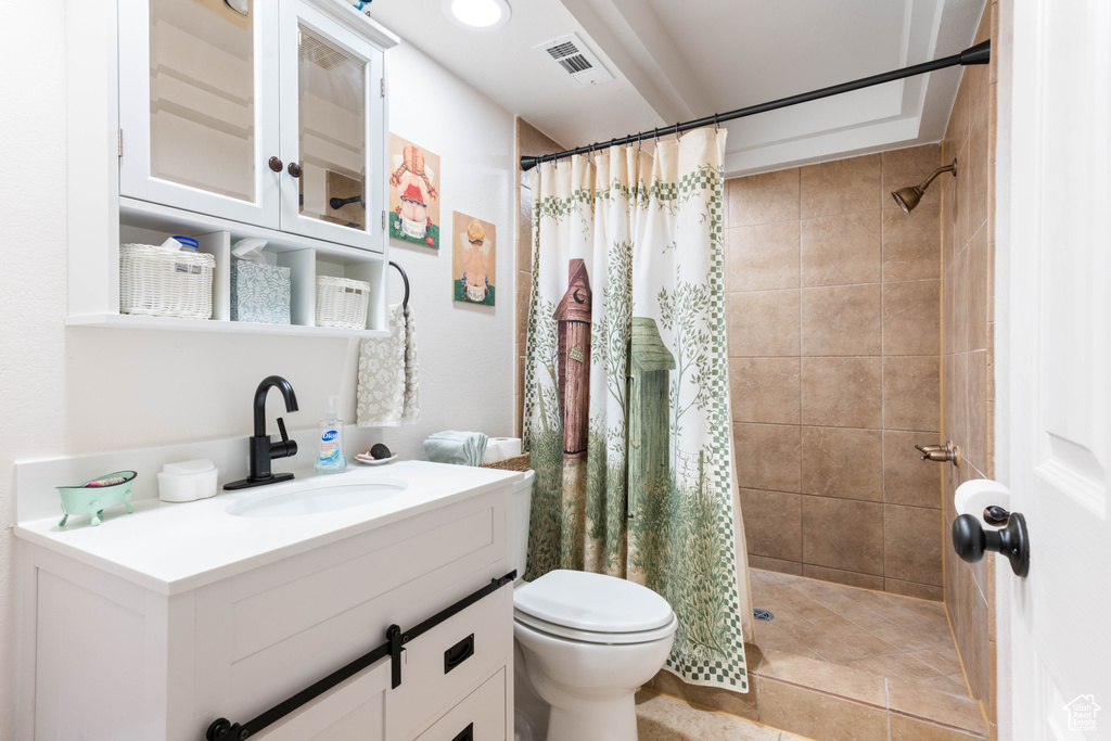 Bathroom with curtained shower, tile floors, toilet, and oversized vanity