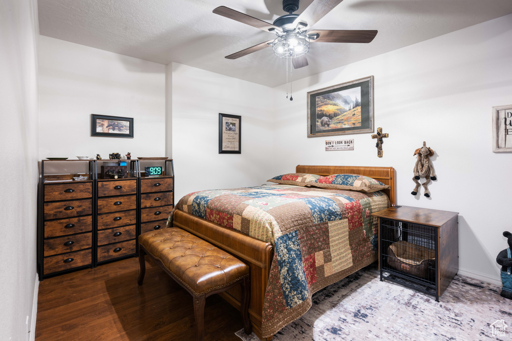 Bedroom featuring ceiling fan and hardwood / wood-style flooring