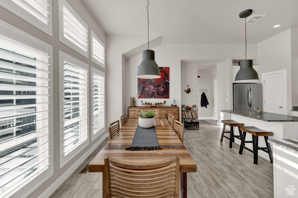 Dining area with light hardwood / wood-style floors