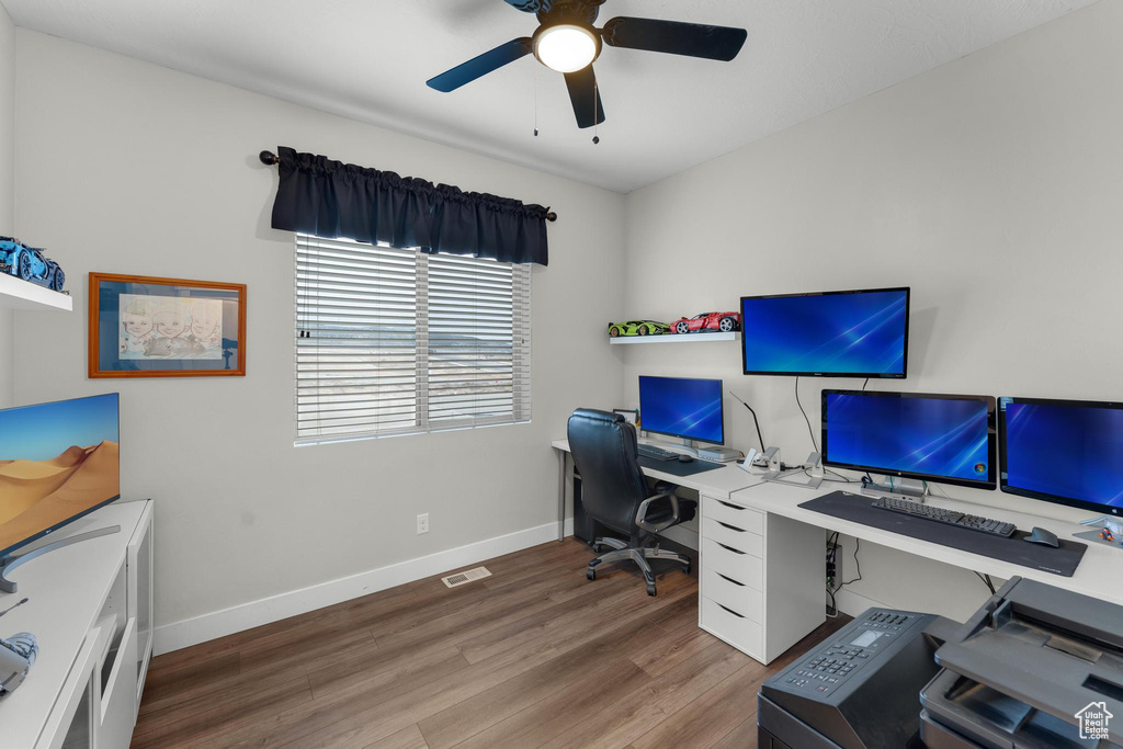 Office space featuring ceiling fan and dark hardwood / wood-style flooring