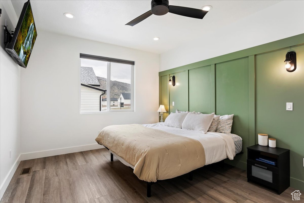Bedroom with ceiling fan and wood-type flooring