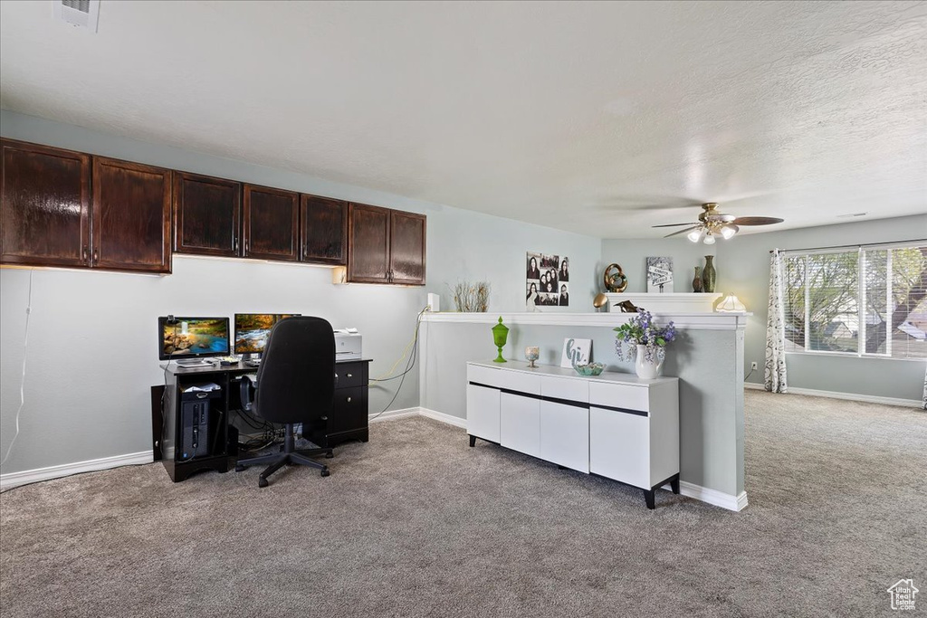 Office area featuring ceiling fan and light colored carpet