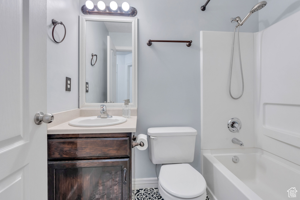 Full bathroom featuring tile flooring, shower / washtub combination, toilet, and large vanity