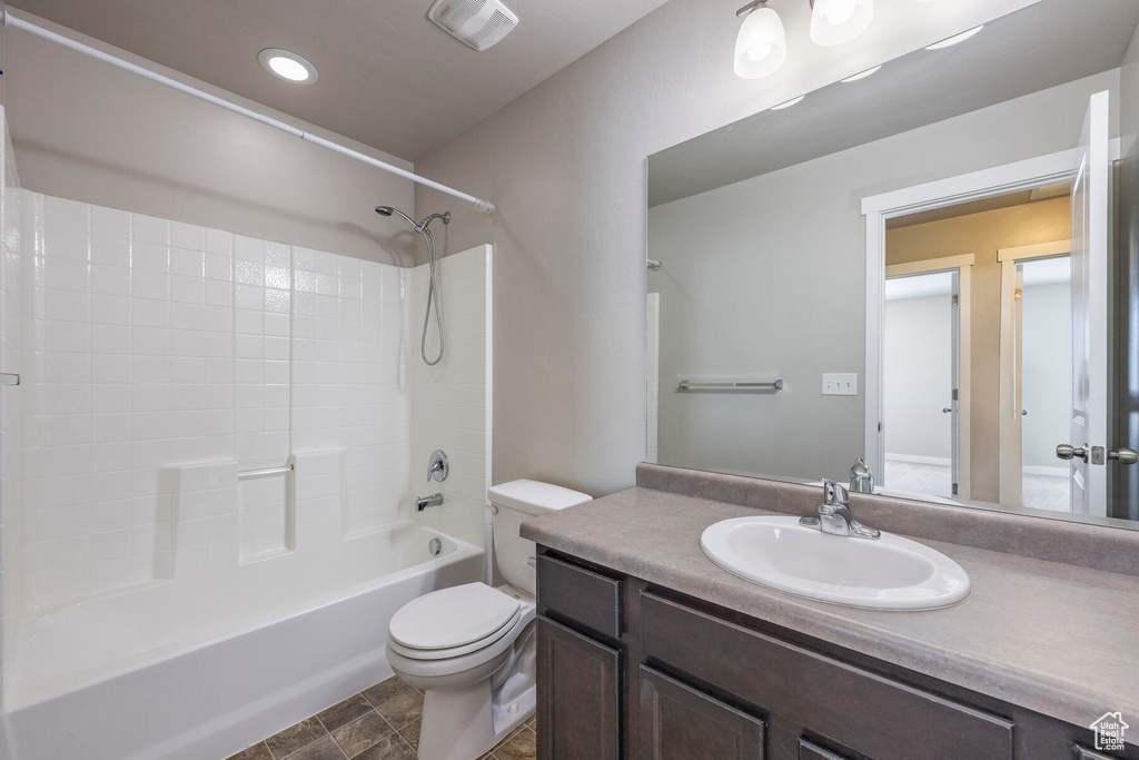Full bathroom with tile flooring, shower / bathtub combination, toilet, and vanity