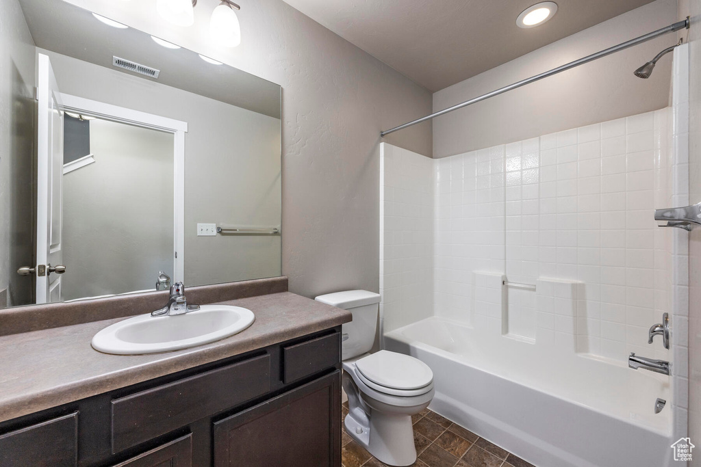 Full bathroom featuring tile flooring, bathing tub / shower combination, toilet, and vanity