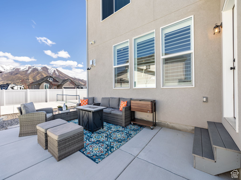 View of terrace featuring an outdoor living space and a mountain view
