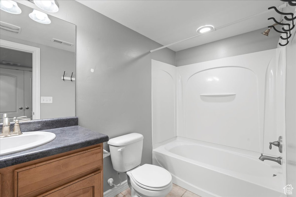 Full bathroom featuring tile flooring, toilet, washtub / shower combination, and vanity