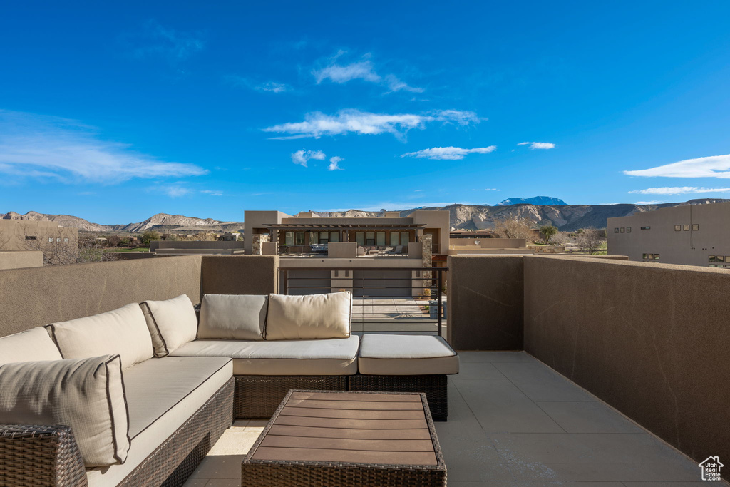View of terrace with a balcony, a mountain view, and an outdoor living space