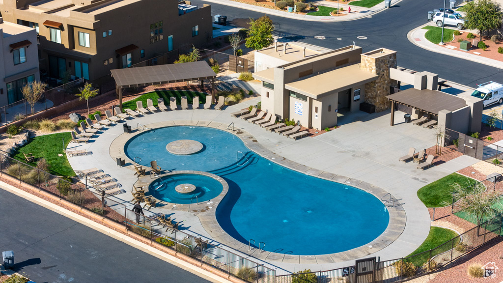 View of swimming pool with a community hot tub and a patio area