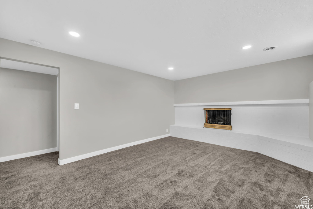 Unfurnished living room with dark carpet
