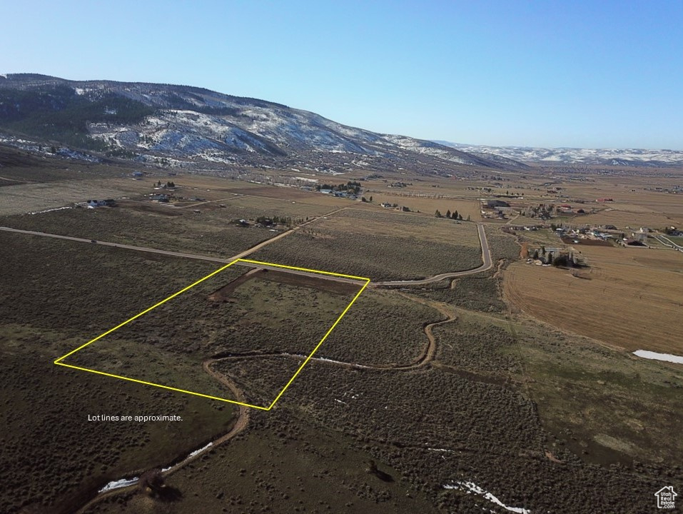 Birds eye view of property with a rural view and a mountain view