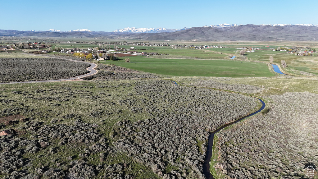 View of home's community with a mountain view and view of golf course