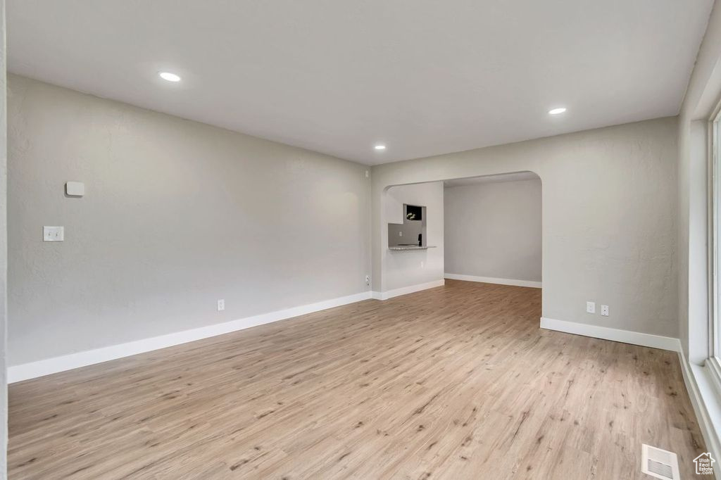 Empty room with light hardwood / wood-style floors