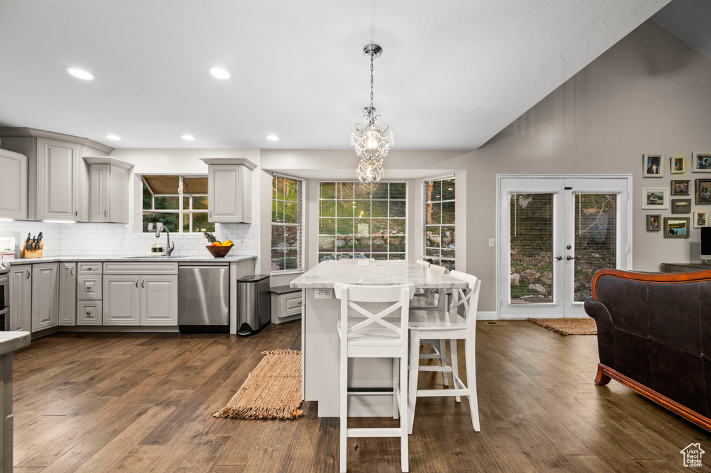 Kitchen featuring an inviting chandelier, dark wood-type flooring, sink, french doors, and stainless steel dishwasher