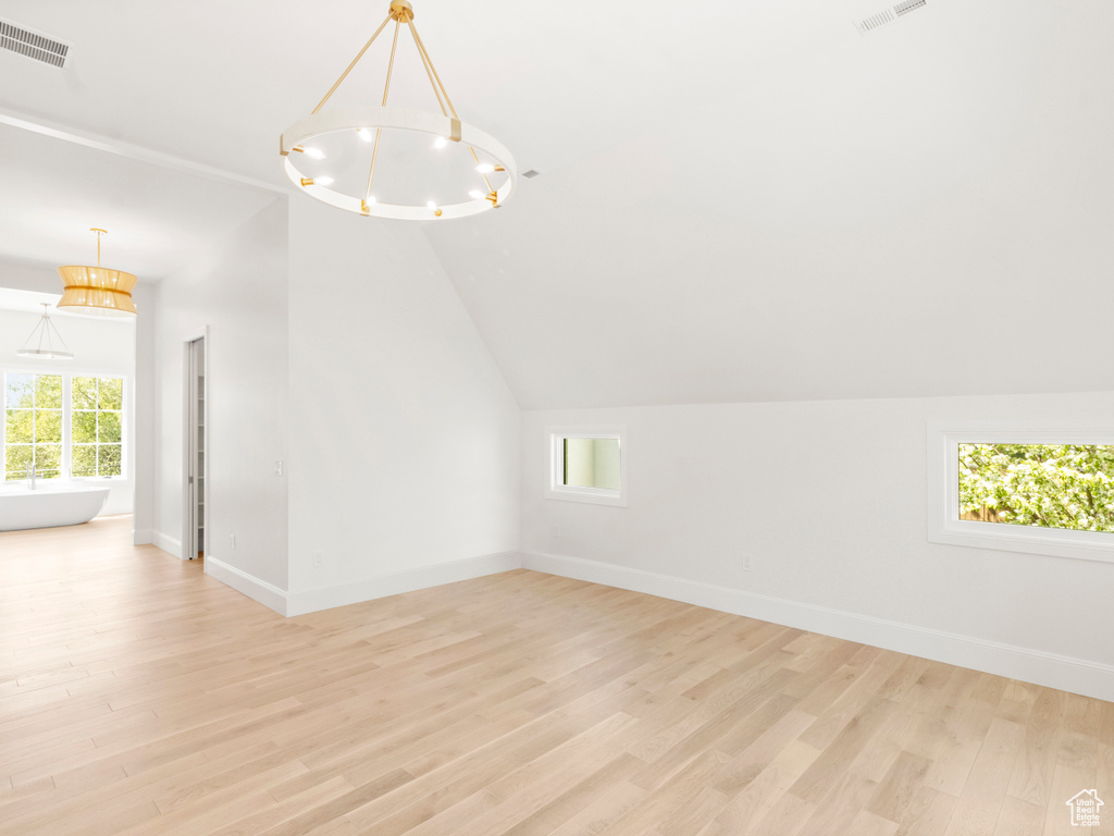 Additional living space featuring lofted ceiling and light hardwood / wood-style floors