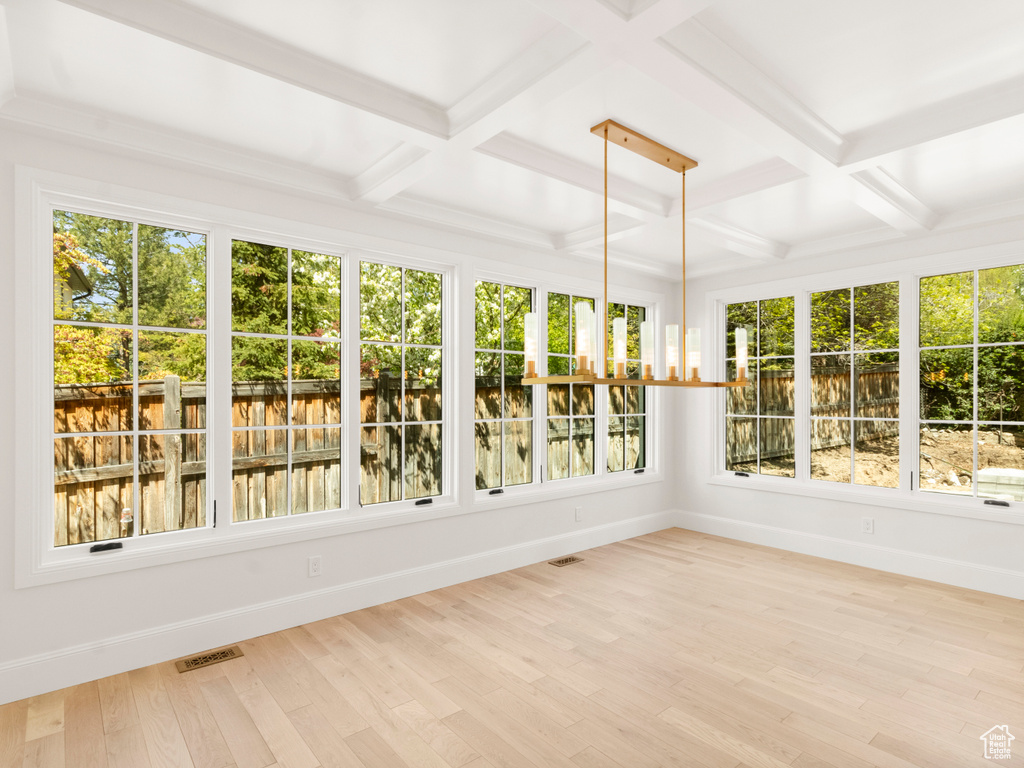 Unfurnished sunroom with a wealth of natural light and coffered ceiling