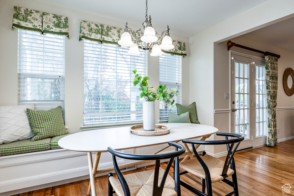 Dining room with a chandelier, light hardwood / wood-style floors, and plenty of natural light