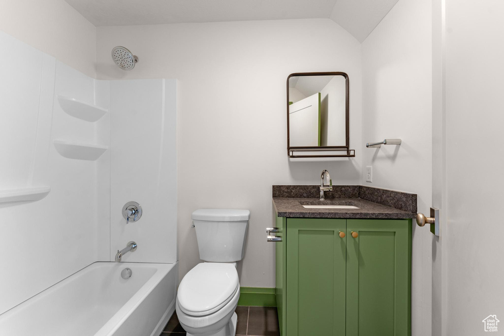 Full bathroom with toilet, vanity, tile floors, and bathing tub / shower combination
