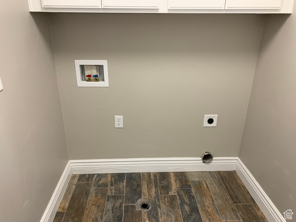 Laundry area with dark hardwood / wood-style flooring, hookup for an electric dryer, cabinets, and hookup for a washing machine