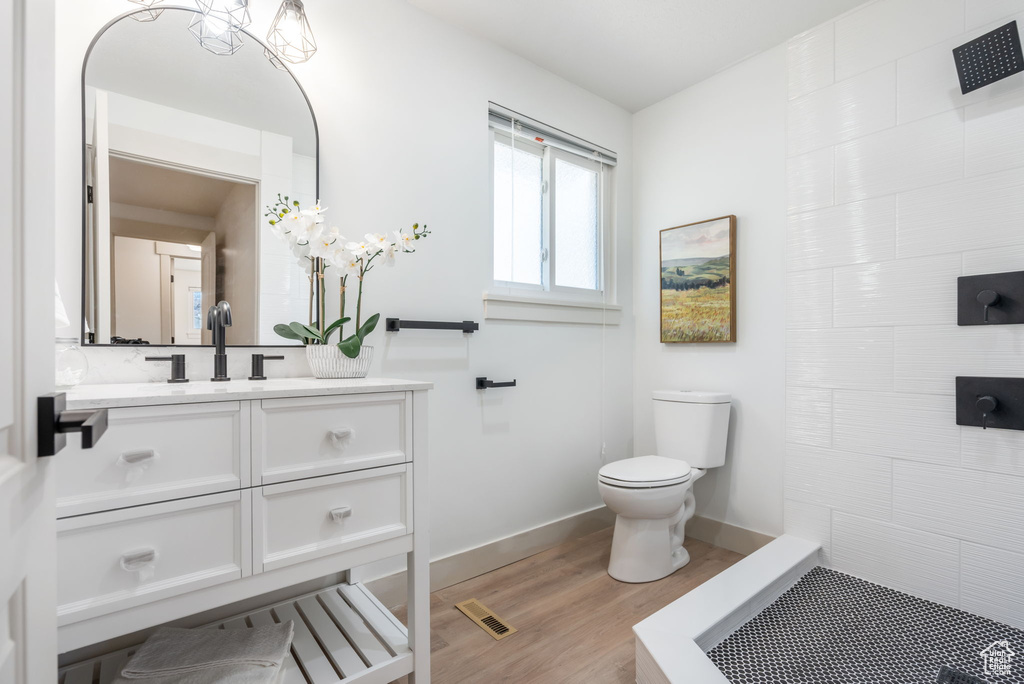 Bathroom with toilet, hardwood / wood-style flooring, and vanity