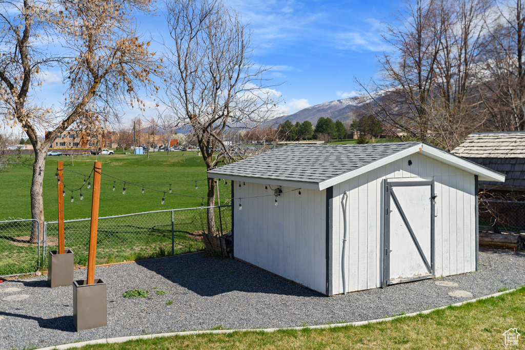 View of outdoor structure featuring a lawn and a mountain view