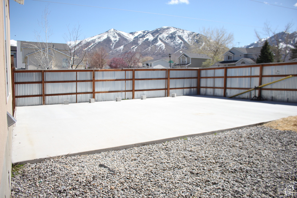 Snow covered patio featuring a mountain view