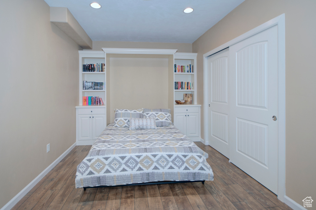 Bedroom featuring hardwood / wood-style floors and a closet