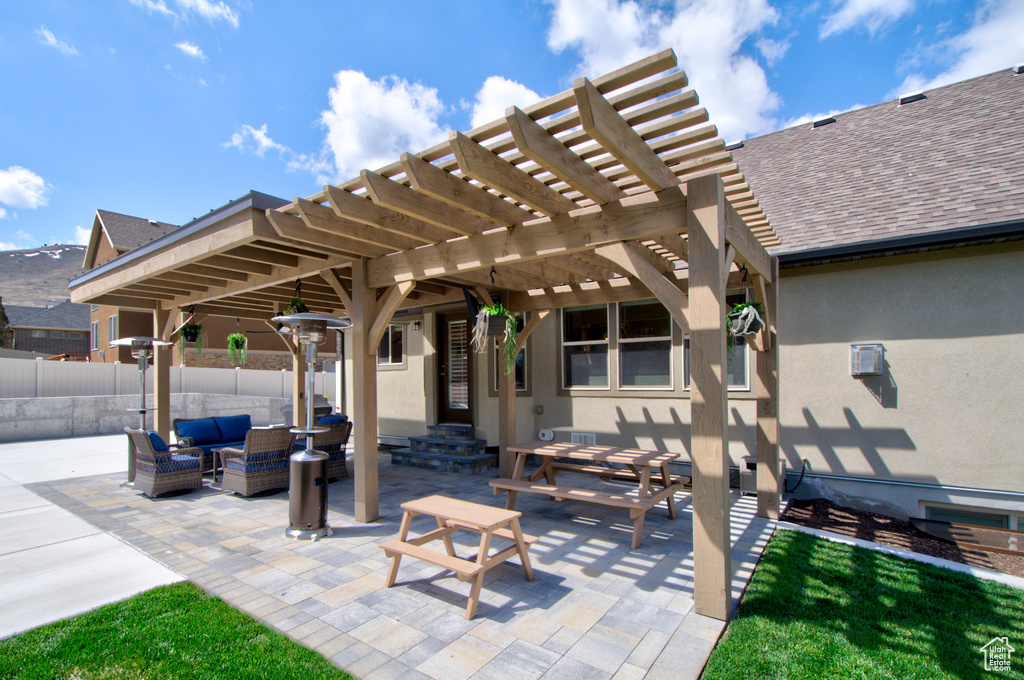View of terrace featuring a pergola and an outdoor living space