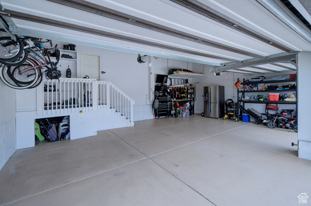 Garage featuring stainless steel fridge