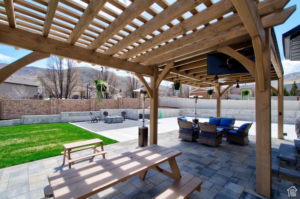 View of patio featuring a pergola, an outdoor hangout area, and a mountain view
