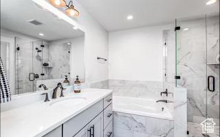 Bathroom with vanity with extensive cabinet space and independent shower and bath