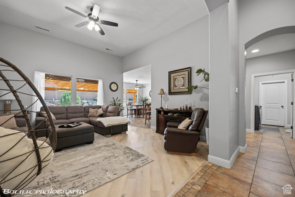 Living room featuring ceiling fan and light tile floors