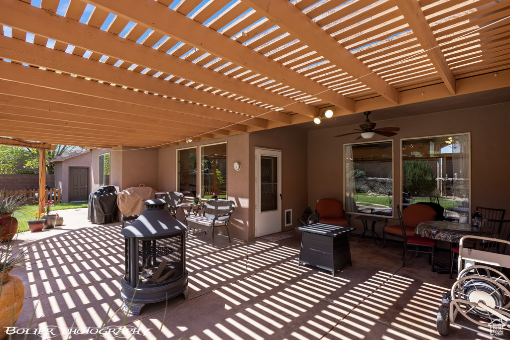 View of patio / terrace with ceiling fan and a pergola