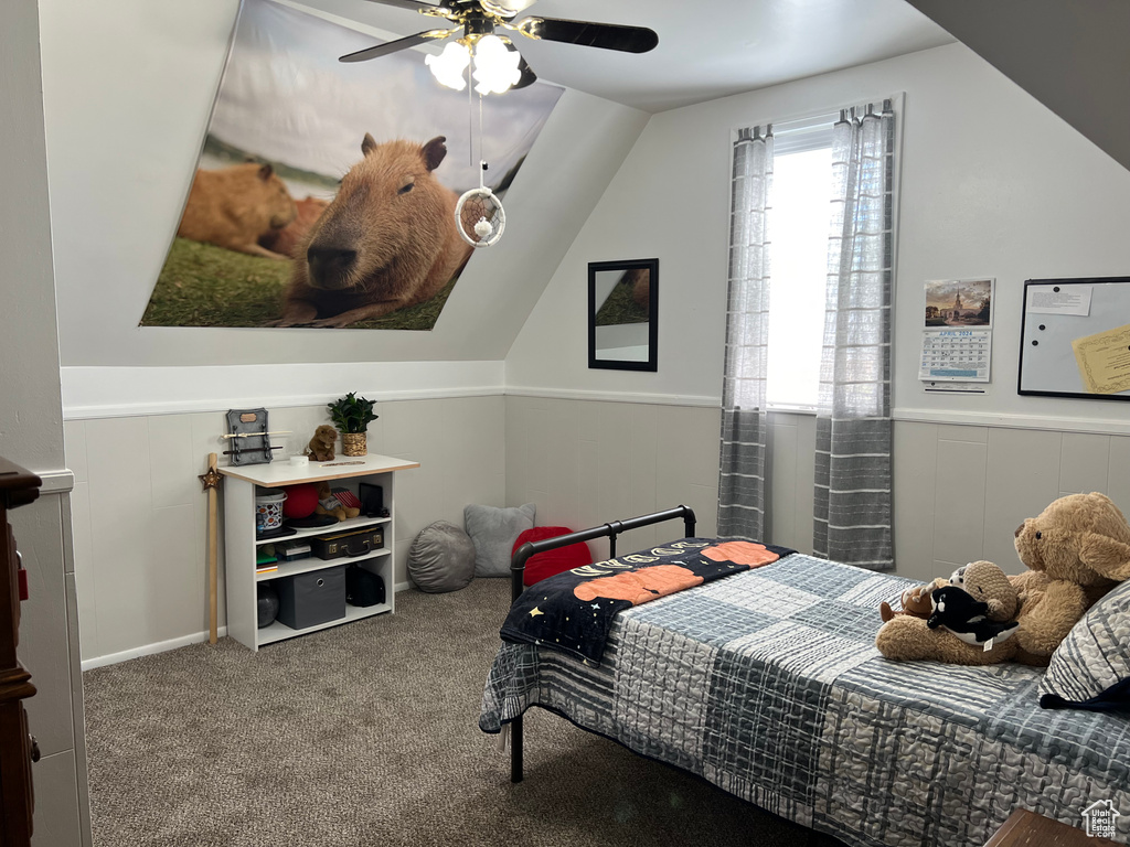 Bedroom featuring carpet flooring, ceiling fan, and lofted ceiling