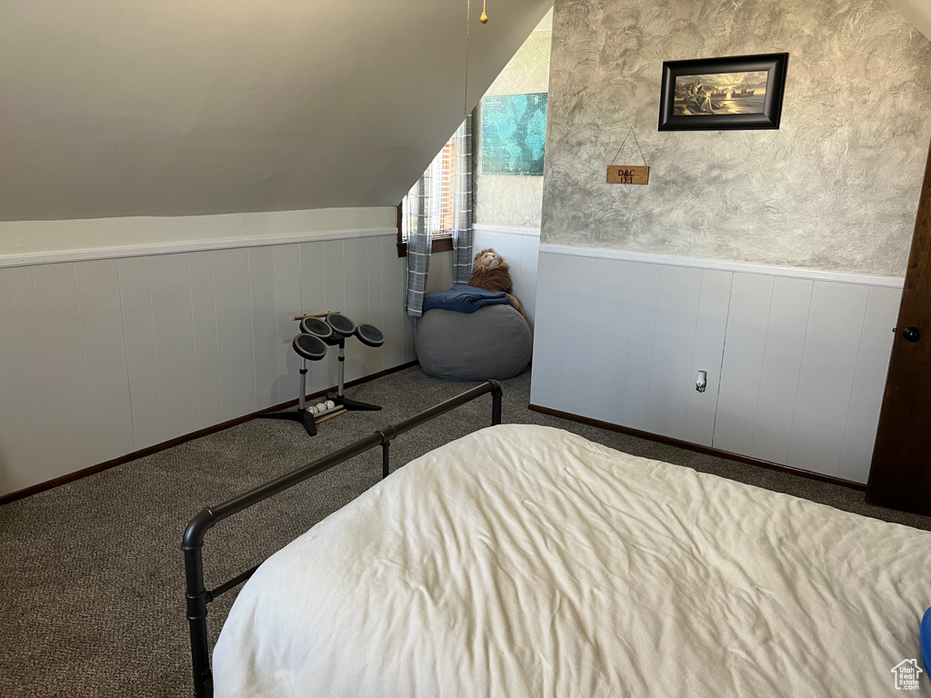 Bedroom with carpet flooring and vaulted ceiling