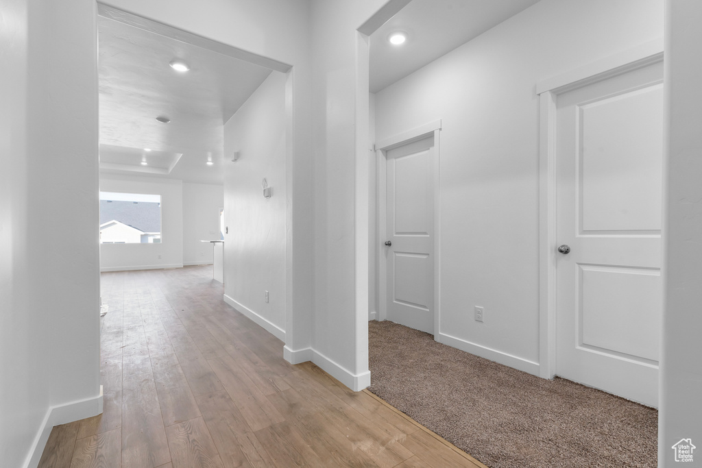 Hallway with light hardwood / wood-style floors