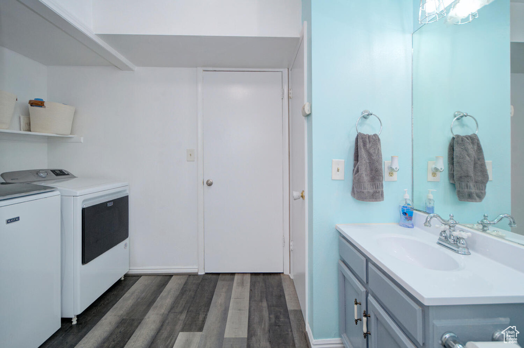 Interior space with vanity, hardwood / wood-style flooring, and washer and clothes dryer