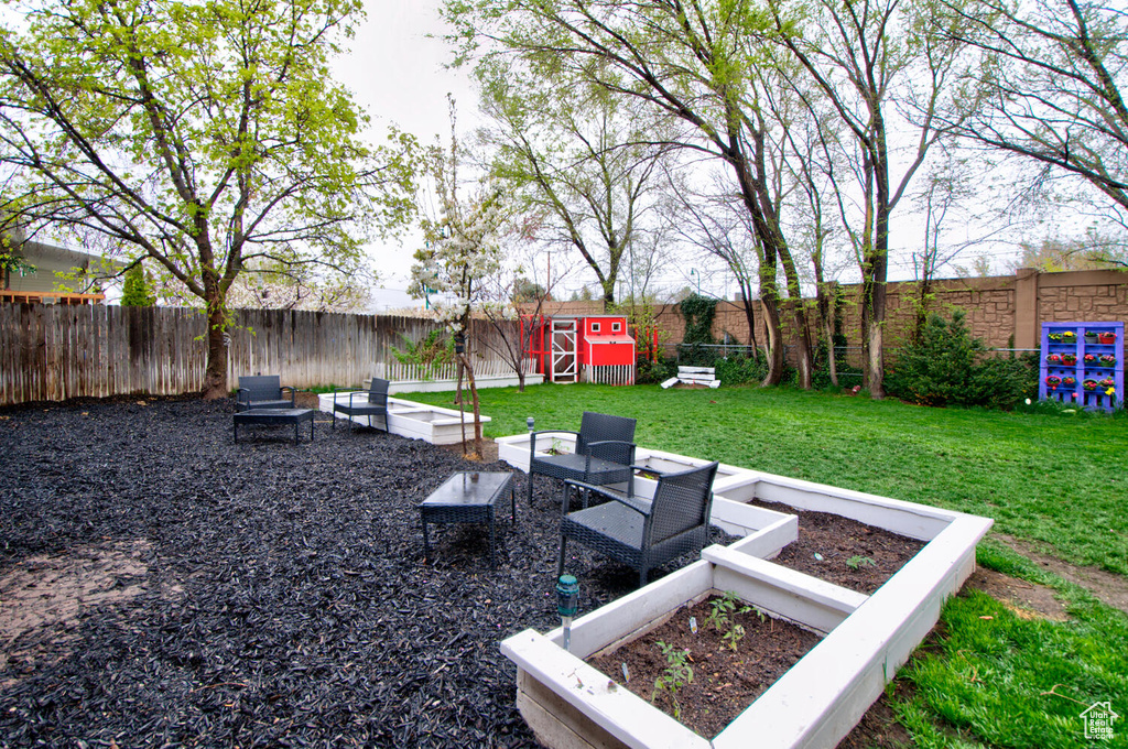 View of yard featuring a storage shed and an outdoor hangout area