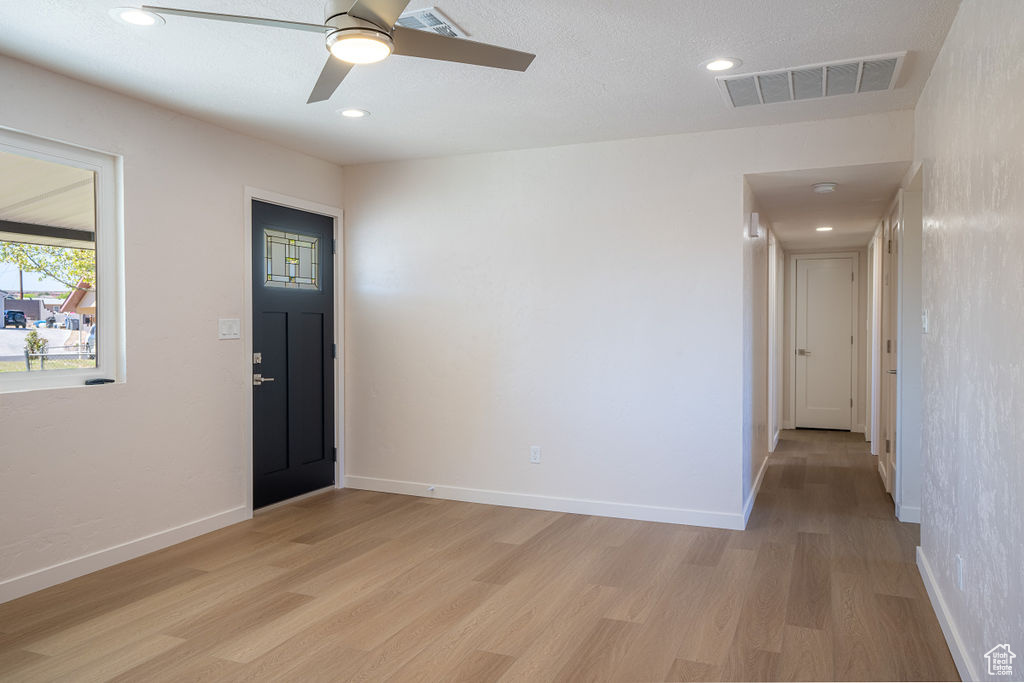 Entrance foyer featuring ceiling fan and light hardwood / wood-style floors