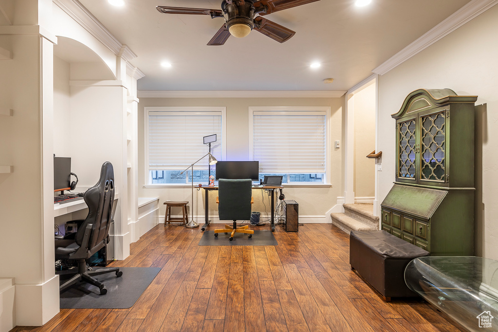 Office with crown molding, dark hardwood / wood-style flooring, and ceiling fan