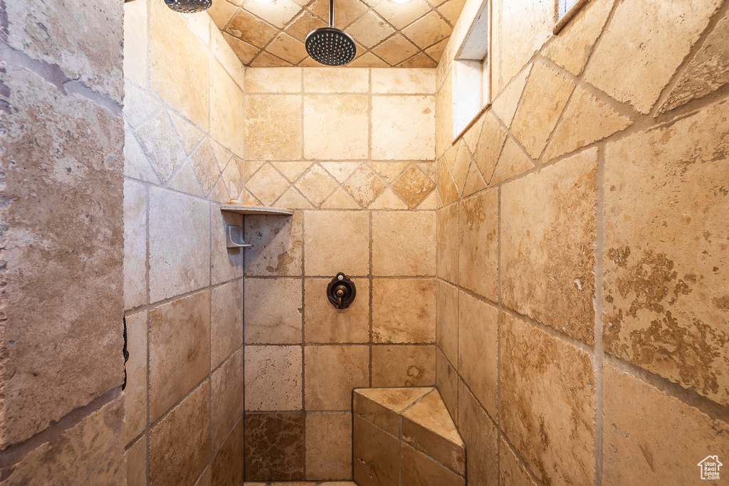 Room details featuring a tile shower