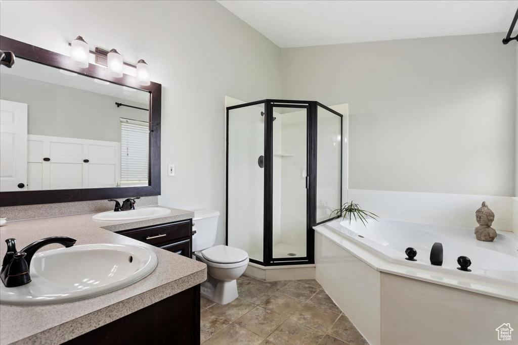 Full bathroom with dual sinks, oversized vanity, plus walk in shower, toilet, and tile floors