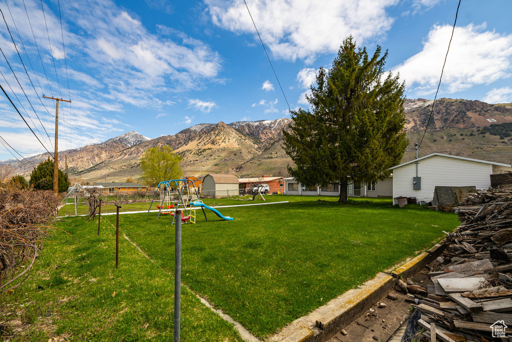 View of yard with a playground and a mountain view