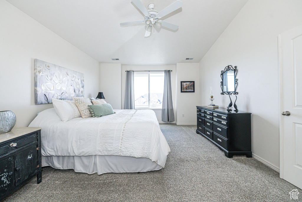 Bedroom featuring ceiling fan, lofted ceiling, and light carpet
