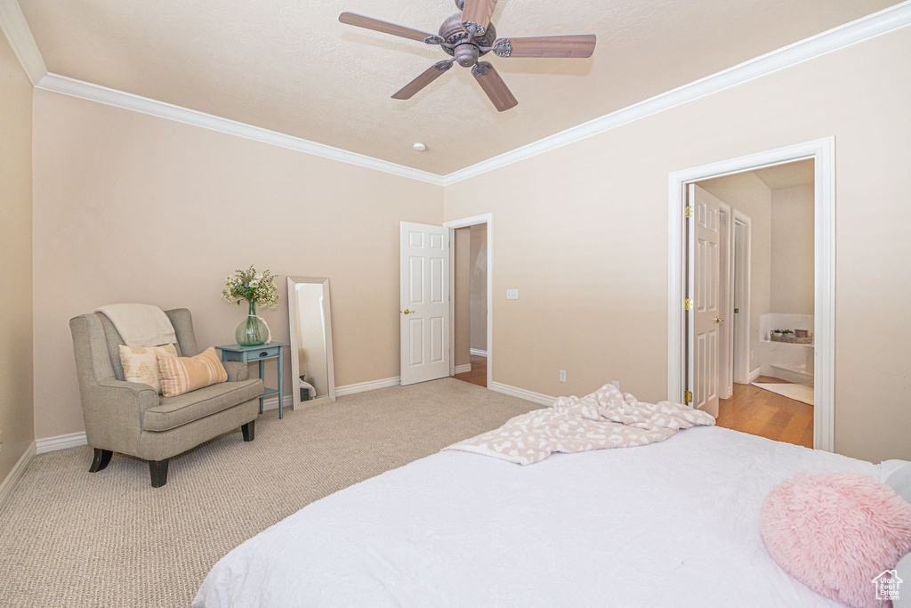 Bedroom featuring crown molding, light colored carpet, ceiling fan, and connected bathroom