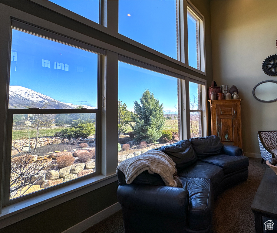 Living room featuring carpet floors, a mountain view, and plenty of natural light