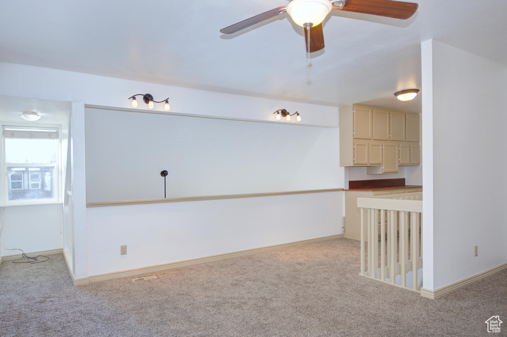 Spare room featuring ceiling fan and light colored carpet